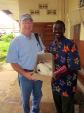 Dr. Maggi receives gift of chicken for his surgery for this man's wife.